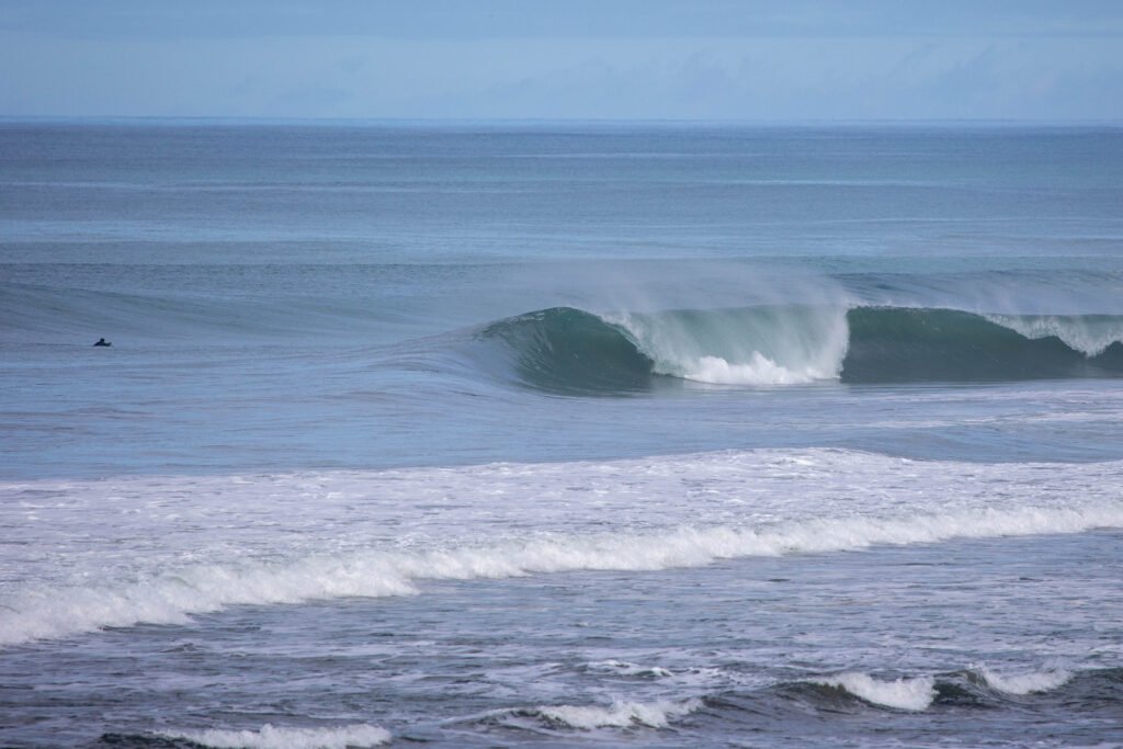 Empty A-frame wave peeling over a sandbar at a Manabi beach break, Ecuador