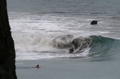 Bodyboarder surfing a left point break