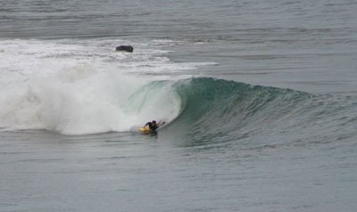 bodyboarder riding a left point break
